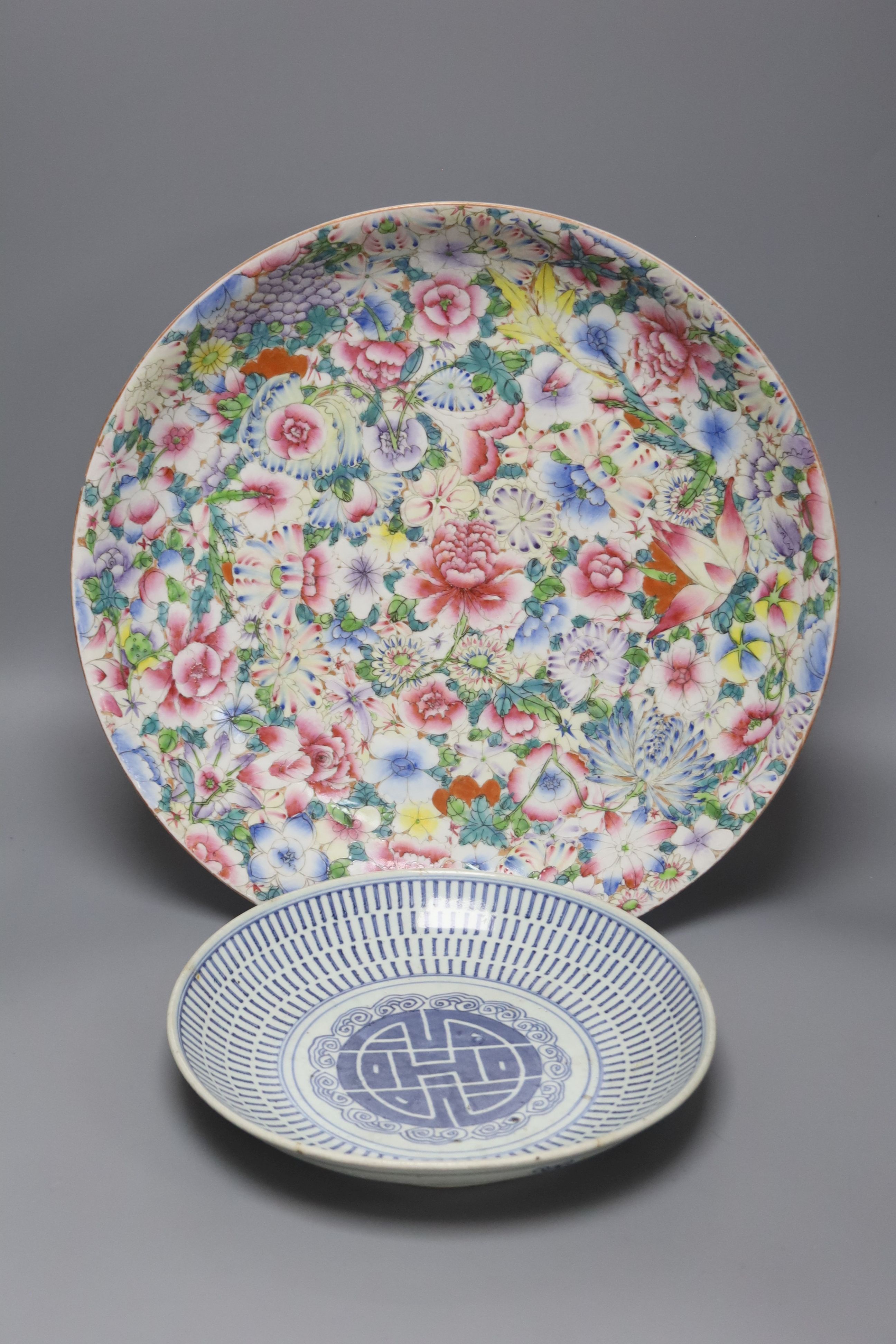 A Chinese thousand flower enamelled porcelain dish, 20th century, 40.5cm, and a mid 19th century Chinese blue and white dish, 26.5cm